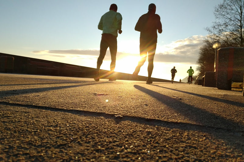 two men running at park