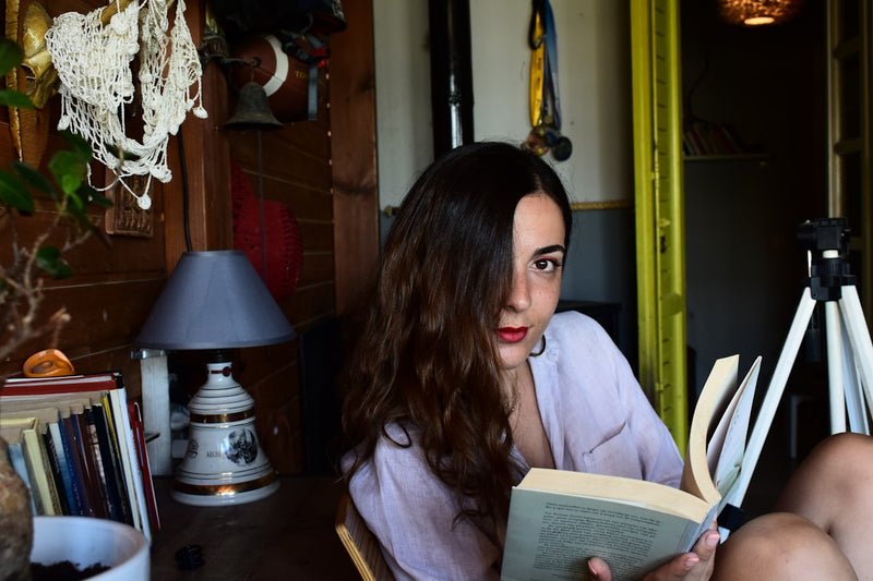 woman in white robe reading book