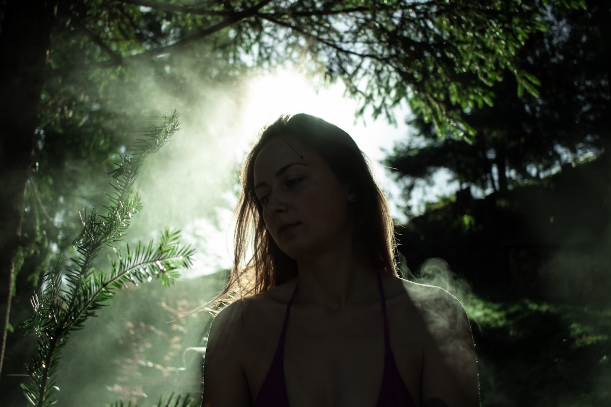 a woman standing in a forest