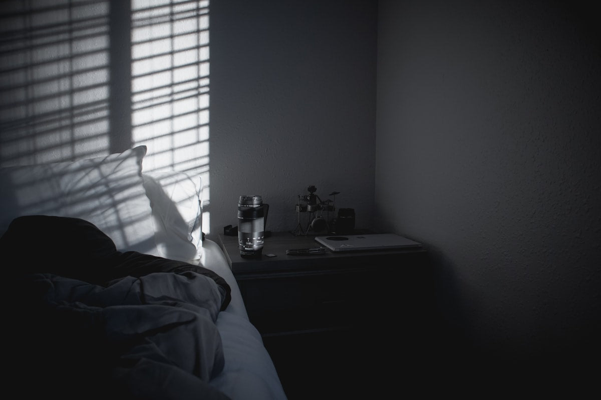 a person's shadow is cast on the wall of a bedroom