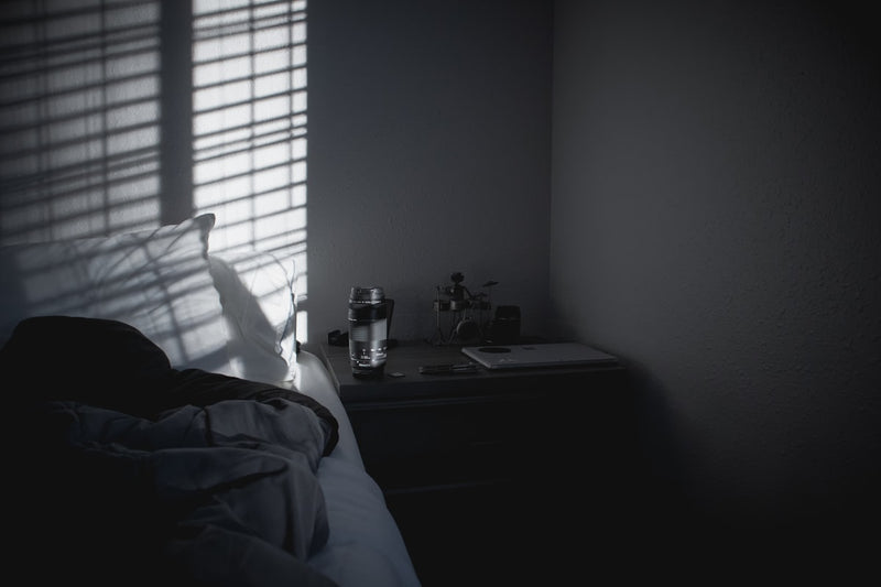 a person's shadow is cast on the wall of a bedroom