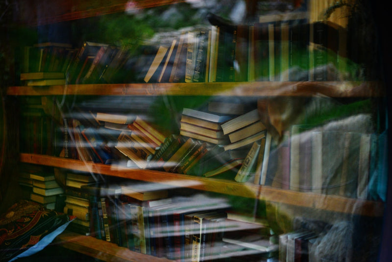 Books on shelves, layered with an artistic effect.