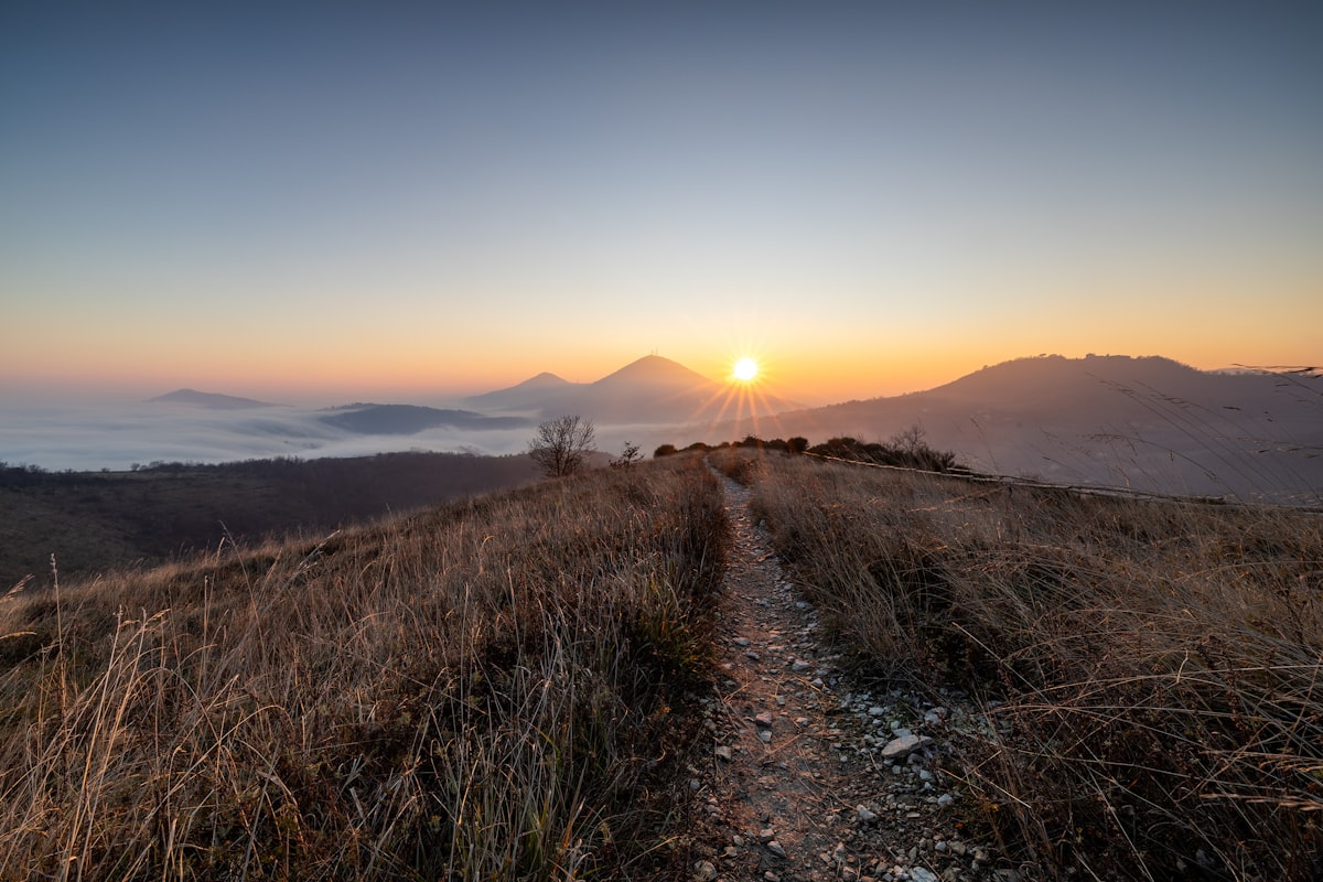 Sunrise over mountains with a path in the foreground